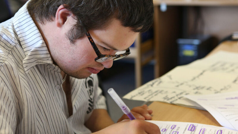 Young Man Reading A non Easy Read Document